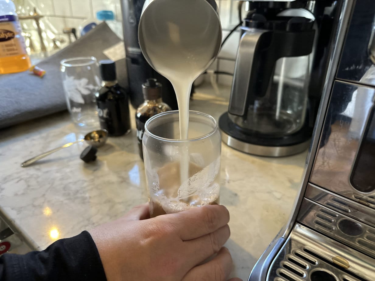 brewed milk is poured into a glass with Jot Ultra Coffee