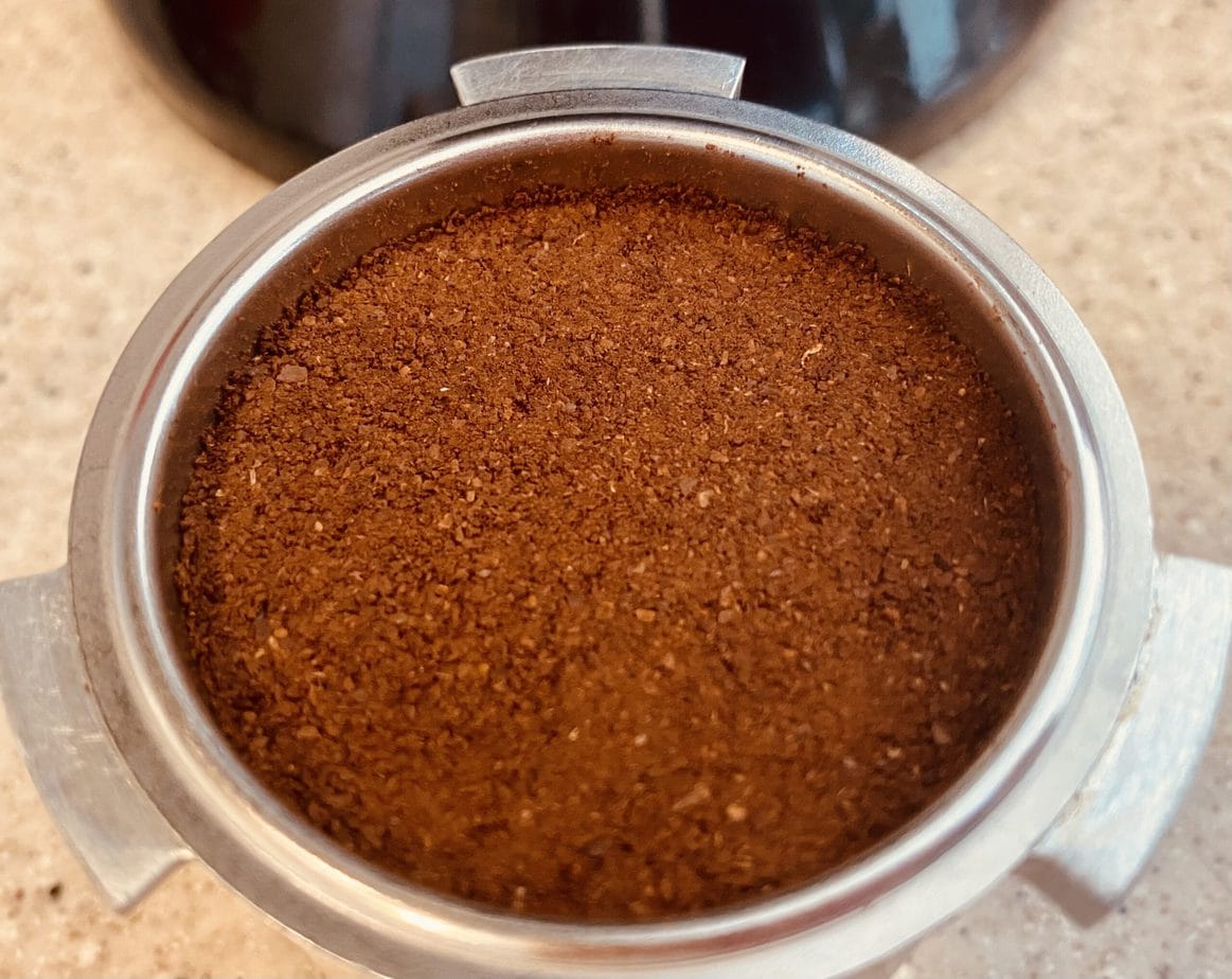 pressured ground coffee in portafilter