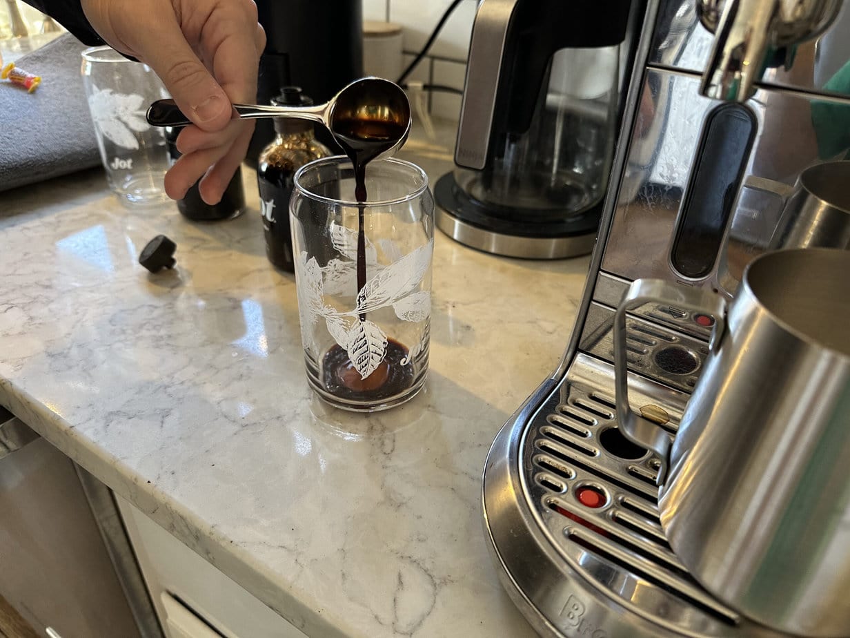 Jot Ultra Coffee is poured from a spoon into a glass