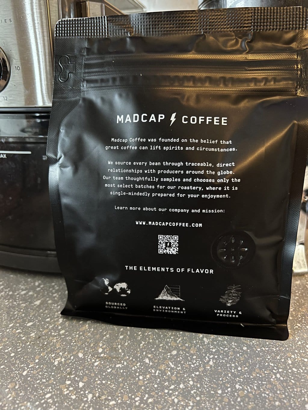 back of Madcap Coffee packaging with coffee history printed close up