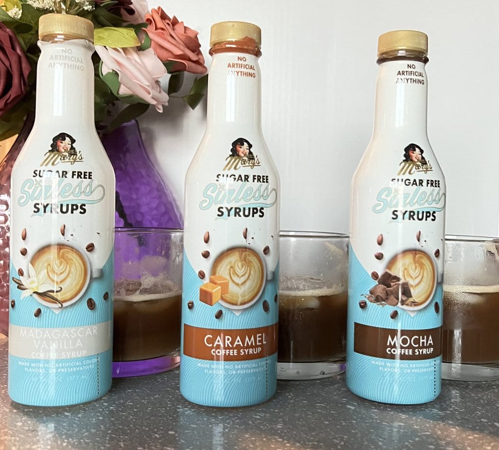 Three different Miss Mary's Sinless Syrups with three brewed cups of coffee