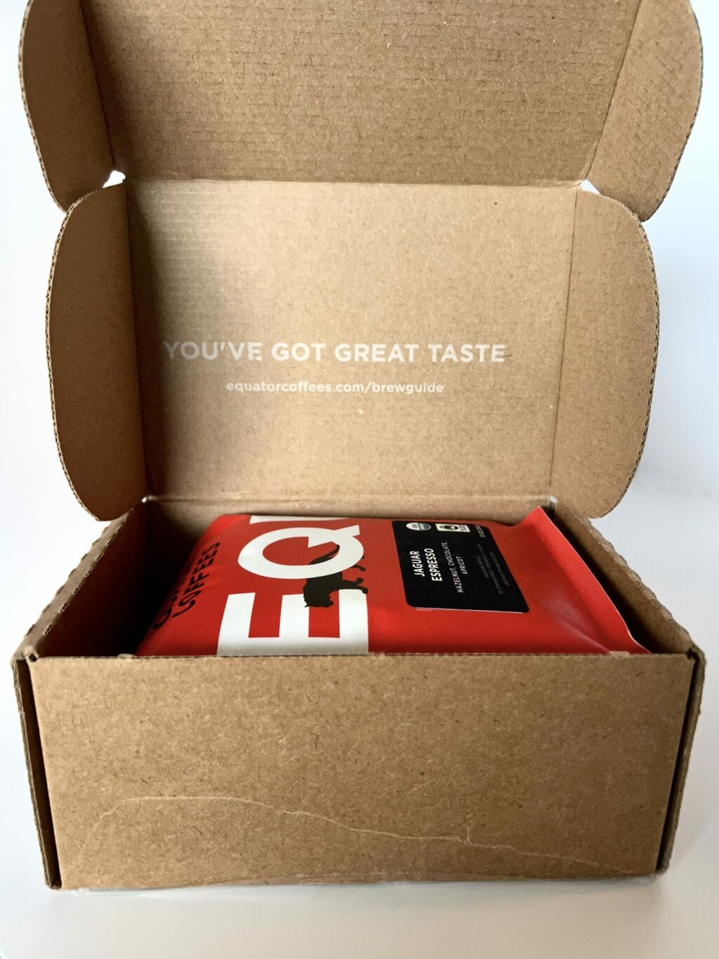 open box with a red pack of Equator Coffees inside