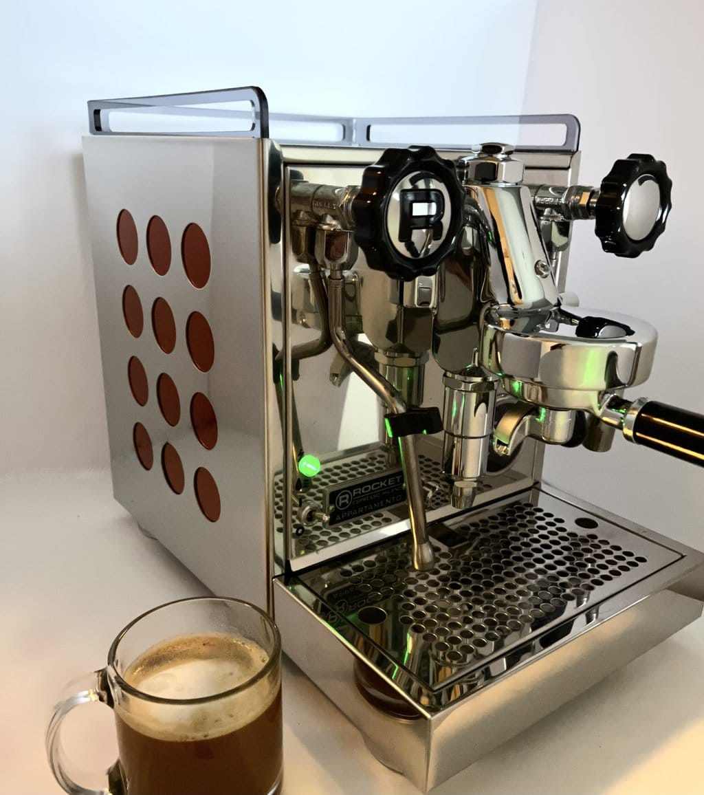 Rocket Espresso Appartamento coffee machine next to a cup of coffee