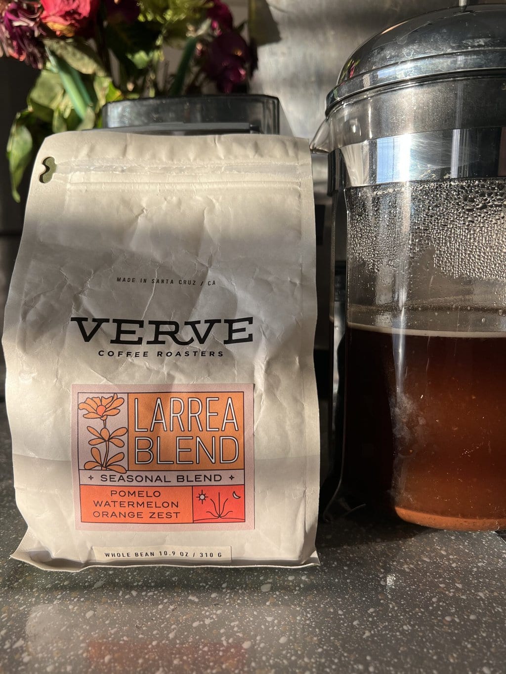 packaging Verve Coffee next to the French press in which coffee is brewed